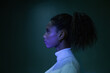 © Anna Berkut/Stocksy - focused and strong black woman, female face in profile, dark