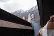 © Milles Studio/Stocksy - Anonymous woman relaxing on terrace in mountains