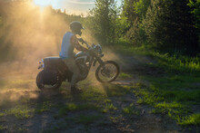 Sunset Light Falls On A Pilot On A Classic Motorcycle
