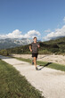 © Alberto Bogo/Stocksy - Young Boy Running in Mountain Resort
