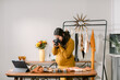 © ByLorena/Stocksy - Pregnant taking photo of fashion design clothes