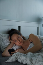 Woman Lying In Bed And Using Smartphone After Awake
