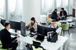 © ZQZ Studio/Stocksy - Casual business people working on computers in open plan office