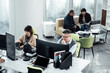 © ZQZ Studio/Stocksy - Casual business people working on computers in open plan office