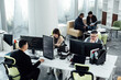 © ZQZ Studio/Stocksy - Casual business people working on computers in open plan office