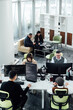 © ZQZ Studio/Stocksy - Casual business people working on computers in open plan office