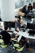 © ZQZ Studio/Stocksy - Casual business people working on computers in open plan office