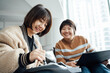 © ZQZ Studio/Stocksy - Two casual businesswoman talking in office