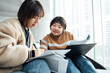 © ZQZ Studio/Stocksy - Two casual businesswoman talking in office