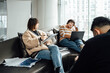 © ZQZ Studio/Stocksy - Casual business people discussing in meeting area of office