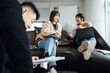 © ZQZ Studio/Stocksy - Casual business people discussing in meeting area of office