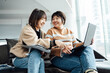 © ZQZ Studio/Stocksy - Two casual businesswoman talking in office