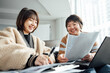 © ZQZ Studio/Stocksy - Two casual businesswoman talking in office