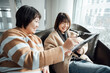 © ZQZ Studio/Stocksy - Two casual businesswoman talking in office