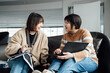 © ZQZ Studio/Stocksy - Two casual businesswoman talking in office