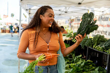 Young Gen-Z Shops For Produce At Farmers Market