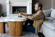 © Sergey Narevskih/Stocksy - Adult man working on online project on laptop in living room