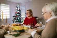 Cheerful Family Enjoining Christmas Dinner At Home