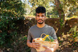 © Valentina Barreto/Stocksy - man holding vegetable basket