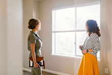 Middlewoman Showing Duplex Rooms To Client