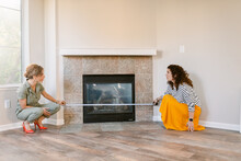 Designers Measuring Fireplace In Empty Home