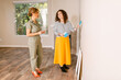 © ByLorena/Stocksy - Owner with designer choosing accent wall colors