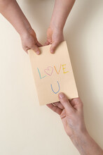 Child Giving Mother Greeting Card With Text Love U
