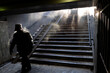 © Amos Chapple/Stocksy - A man walks through an underpass on a freezing day