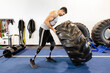 © Dylan Leeder/Stocksy - Double Leg Amputee Flips A Tire