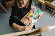 © Ezequiel Giménez/Stocksy - Painter creating artwork on canvas in workshop