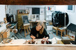 © Ezequiel Giménez/Stocksy - Blond woman working on illustration