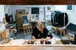 © Ezequiel Giménez/Stocksy - Female artist drawing on desk