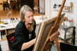 © Ezequiel Giménez/Stocksy - Artist painting on canvas in workshop