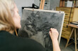 © Ezequiel Giménez/Stocksy - Craftswoman painting with charcoal on canvas