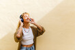 © Michela Ravasio/Stocksy - Happy woman listening to music