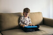 © Pedro Merino/Stocksy - Kid with tablet at home