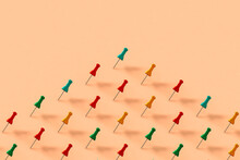 Collection Of Colorful Push Pins On Pink Background