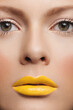 © Alexandra Bergam/Stocksy - Woman beauty with yellow lipstick
