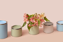 Diagonal Row Of Colored Paint Tins With Spring Flowers