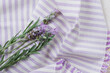 © Shava Cueva/Stocksy - lavender flowers on a purple folded tablecloth