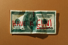 Text I Have A Gun Written In A 100 Dollar Note