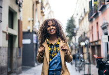 Smiling Woman Walking Down The Street