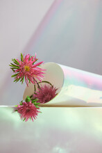 Bouquet Of Pink Flower Among A Roll Of The Sparkling Paper Sheet