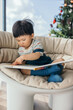 © Heng Yu/Stocksy - little baby boy reading