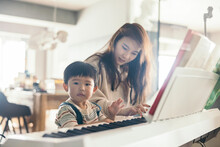 Asian Little Baby Boy Playing Piano With His Mom