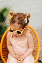 Girl Having Buns And Wearing Flower Hair Clips And Sunglasses