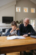 © Ameris Photography Inc./Stocksy - Mature man helping kid with schoolwork