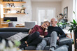 © Ameris Photography Inc./Stocksy - Older couple looking happy together on couch.