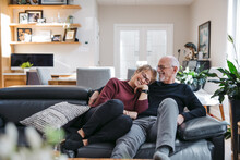 Older Couple Looking Happy Together On Couch.