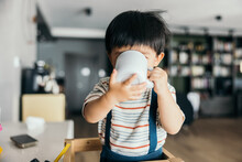 Little Boy Drinking From A Cup
